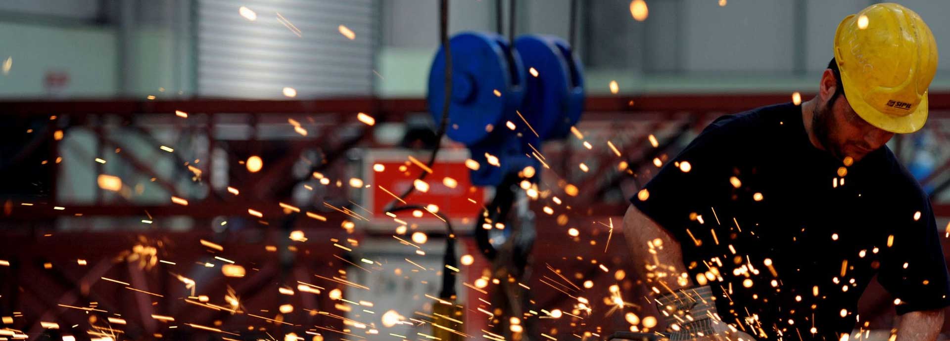 Metalwork with sparks flying in an industrial workshop